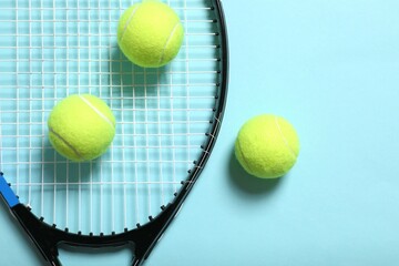 Tennis racket and balls on color background