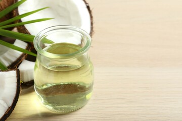 Jar of coconut oil on wooden background
