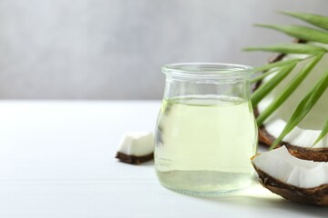 Jar of coconut oil on wooden background