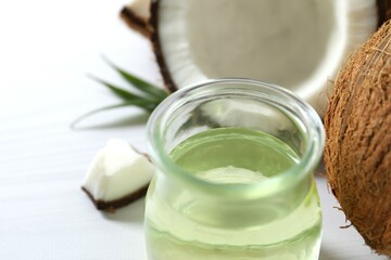 Jar of coconut oil on wooden background