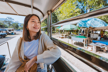 Travel local transport concept Happy traveler asian woman relax and sightseeing inside car truck in...
