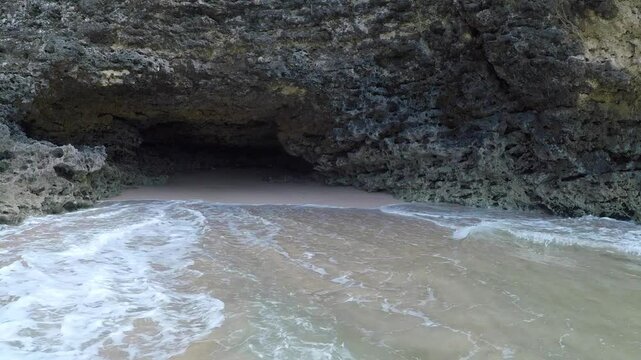 The cave on the rocks of the secret beach near Pantai Tegal Wangi, Bali, Indonesia