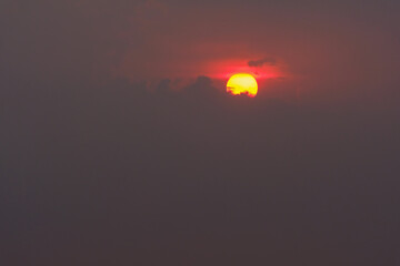 Gorgeous scenic of the strong sunset with silver lining and cloud on the orange sky