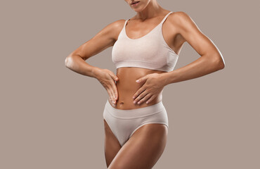 Obraz premium Slender dark-skinned woman with clean well-groomed skin in underwear. Healthy lifestyle, sports and diet.
