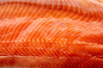 Organic Raw Salmon Fillet on a wooden board, top view. Flat lay, overhead, from above. Close-up.