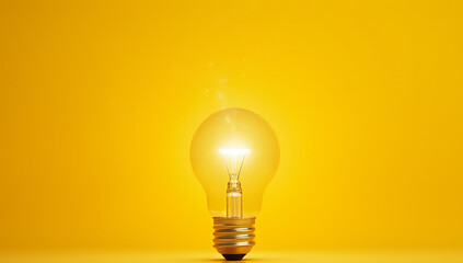A sparking idea is conceived when a lightbulb moment occurs above a bright yellow background near an ordinary desk lamp._00002_