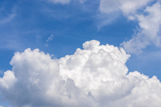 A big white cloud in the blue sky on a beautiful Sunny day. as a background
