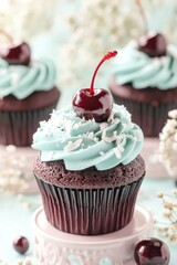 A close-up of a chocolate cupcake with blue frosting and a cherry on top.