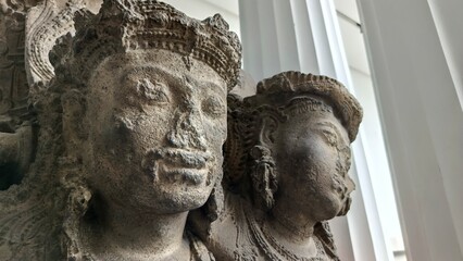 Close-up of ancient stone sculptures depicting deities, showcasing intricate details and historical significance