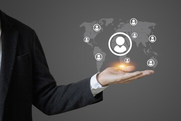 A man is holding a hand up to show a globe with people on it. The globe is surrounded by a circle with a person in it