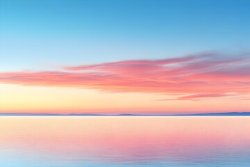 Fototapeta premium Serene pink and blue sunrise over calm water.