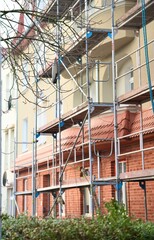 Scaffolding is installed for exterior renovation of the building facade.