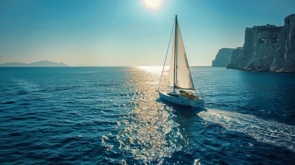 Obraz premium A stunning yacht gracefully navigating the mediterranean with crystal clear skies and coastal cliffs
