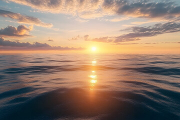 Obraz premium A serene sunset over the ocean, reflecting warm colors on the water.