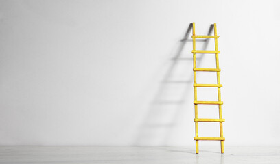 Creativity,solution,innovation,idea,thinking out of the box concept, white wall with ladder of success. Large free copy space,negative space technique