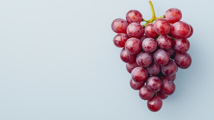 A cluster of fresh red grapes on a light background, showcasing their round shape and natural shine.