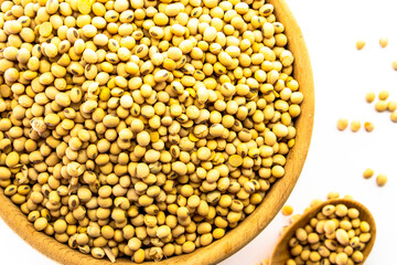 Organic soy beans falling into a rustic wicker bowl. Raw dried soya grains. Healthy legume ingredient. Rotation. Food