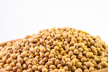 Organic soy beans falling into a rustic wicker bowl. Raw dried soya grains. Healthy legume ingredient. Rotation. Food