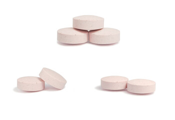 A set of pink pills isolated on white background