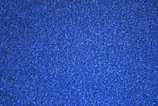 Blue color sparkle glitter paper background close up