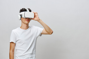 Virtual reality experience, young man wearing VR headset, white background, modern technology,...