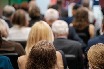 Fototapeta premium People sitting in rows, listening attentively during a business or educational conference.