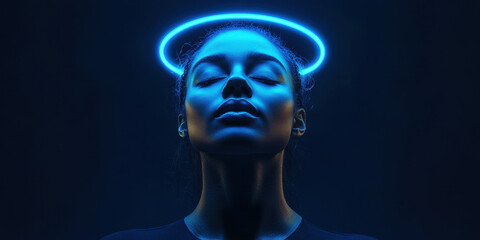 Obraz premium A woman with closed eyes is illuminated by a vibrant blue halo, set against a dark background. The contrast highlights her serene expression, creating a captivating atmosphere.