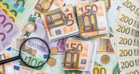 hand magnifier over EU euro paper bills