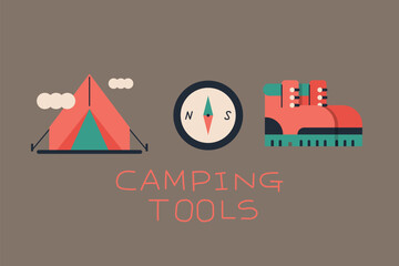 Photo of camp with tents and camp set up. Hiking boots and compass.