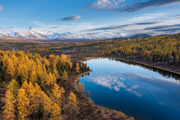 Naklejka premium Capturing stunning Altai mountains in fall, tranquil lake reflecting vibrant foliage and serene nature.