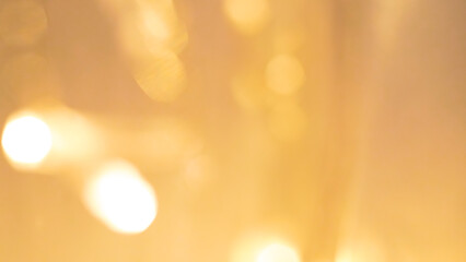 Glowing golden bokeh lights creating a warm, festive, and dreamy background.