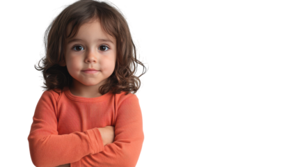 Young child with curly hair crossing arms, displaying confidence in a neutral setting.