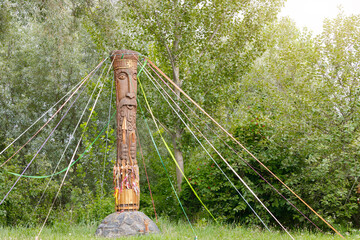 wooden carved pillar of pagan god spring season ancient holidays ethnic cultural folklore concept...