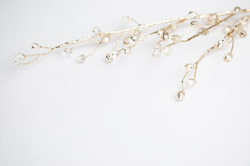 Gold twig decoration with balls on white background