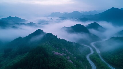 Scenic misty valley with glowing mountains at sunrise