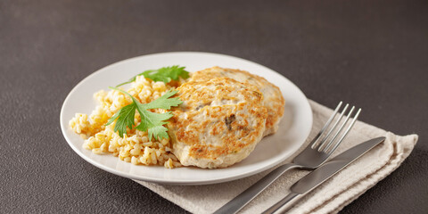 Chicken or vegetable cutlets with a side dish of bulgur in a plate on the table. Diet nutrition