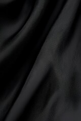 Obraz premium Black textured fabric shows subtle folds and drapes