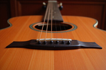 Fototapeta premium Acoustic guitar bridge neck body and strings in detail