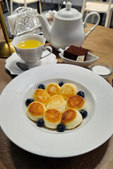 Tea set, cheesecakes and blueberries for breakfast