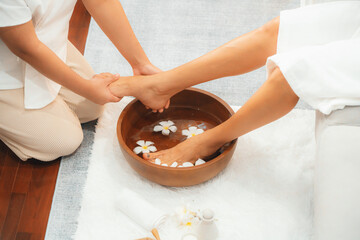 Woman indulges in blissful foot massage at luxurious spa salon while masseur give reflexology...