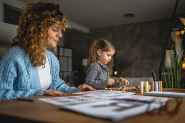 Fototapeta premium little girl and speech therapist practice together at home