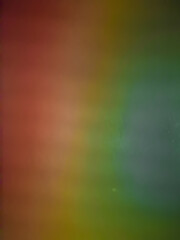 A vibrant abstract background with a gradient of colors, including red, orange, yellow, green, and blue. The colors blend seamlessly, creating a sense of movement and energy. The background is perfect