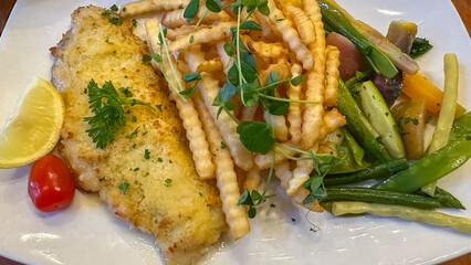 Fried, Breaded Fish, French Fries, And Sautéed Vegetables