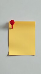 A red pin fastens yellow note paper on textured background.