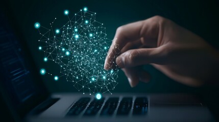 A hand interacts with digital data visualization above a laptop keyboard.