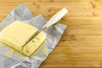 A stick of butter placed on a cutting board, increase in butter prices, food prices