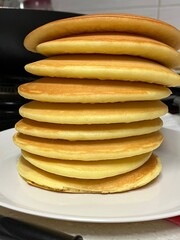 Healthy summer breakfast,homemade classic american pancakes with fresh berry and honey, morning light grey stone background copy space top view

