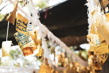 Golden sheet cloth that is tied to line along with writing message. For blessing of the sacred of...