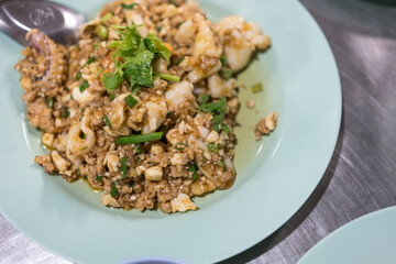 Stir fried minced pork, squid with salted egg. Thai style food