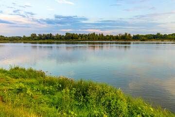 Vistula river landscape at summer early evening with riverside with wild beaches and embankment near Czerwinsk village in Mazovia region of Poland